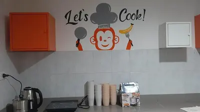 a kitchen with a chef sign on the wall at Owl's Nest suk 30 in Bangkok