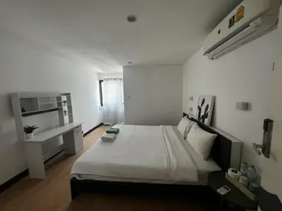 a bedroom with a large bed in a room at Owl's Nest suk 30 in Bangkok
