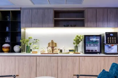 a kitchen with a counter with a coffee maker on it at Benjarong Hotel Bangkok Ratchada in Bangkok