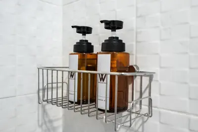 two bottles ofodorizers sit on a shelf in a bathroom at Hotel Wizpark Ratchada in Bangkok