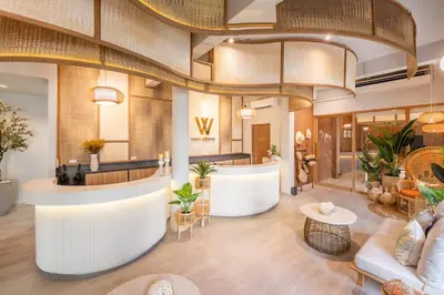 a lobby of a hotel with a reception counter and tables at Hotel Wizpark Ratchada in Bangkok