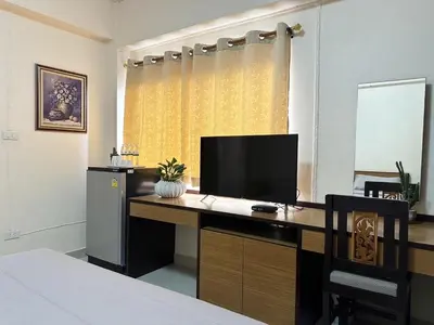 a bedroom with a desk with a television on it at 66 Apartment in Ban Khlong Nong Yai