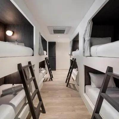 a group of bunk beds in a dorm room at Lilit Bang Lumphu Hotel in Bangkok