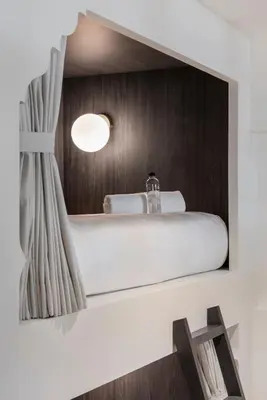 a bathroom with a white sink and a mirror at Lilit Bang Lumphu Hotel in Bangkok