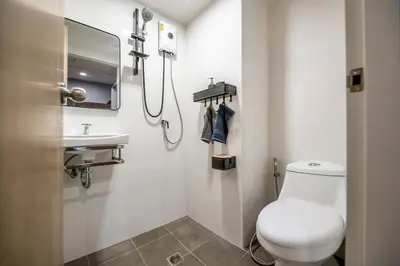 a bathroom with a toilet and a sink at C2 stay Phayathai in Pom Prap