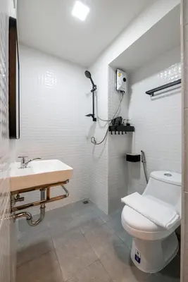 a bathroom with a toilet and a sink at C2 stay Phayathai in Pom Prap