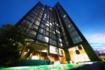 a tall building with a lot of windows at The Rich Residence Sukhumvit Nana in Bangkok