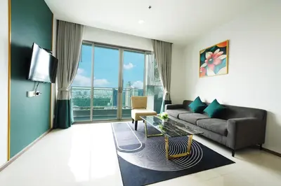 a living room with a couch and a tv at The Rich Residence Sukhumvit Nana in Bangkok