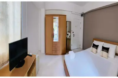 a bedroom with a bed and a flat screen tv at Grandview Place in Bangkok