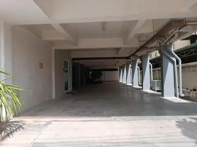 an empty hallway of a building with columns at Grandview Place in Bangkok