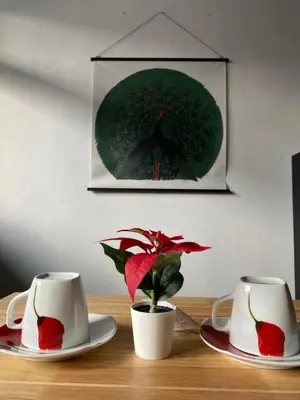 two coffee cups and a potted plant on a table at Freedom8 in Khlong San