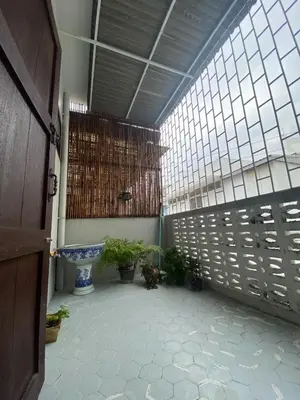 a large room with a large window and plants at Freedom8 in Khlong San