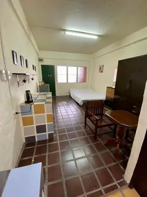 a room with a bedroom with a bed and a table at Ratanawong Place 511 in Bangkok