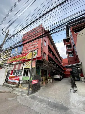a building on a street with power lines above it at Ratanawong Place 511 in Bangkok