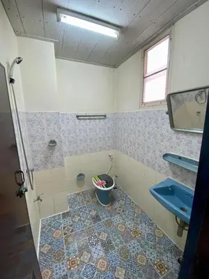 a bathroom with a toilet and a sink and a bucket at Ratanawong Place 511 in Bangkok