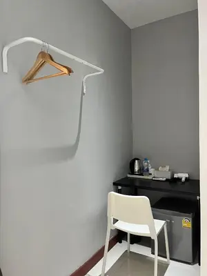 a white chair sitting in front of a desk at Aowmana Hotel in Makkasan