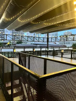 a balcony of a building with a view of a bridge at Aowmana Hotel in Makkasan