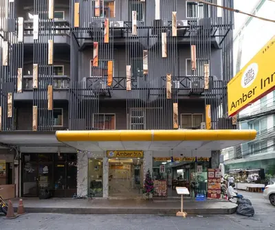 a large yellow surfboard on top of a building at Amber Inn in Bangkok