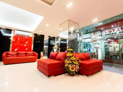 two red couches in front of a store at Royal Asia Hotel Pratunam in Bangkok