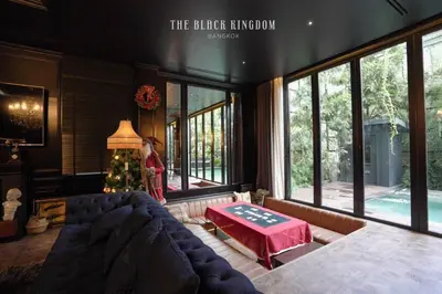 a living room with a couch and a table at The Black Kingdom - เดอะ แบล็ค คิงดอม in Bangkok