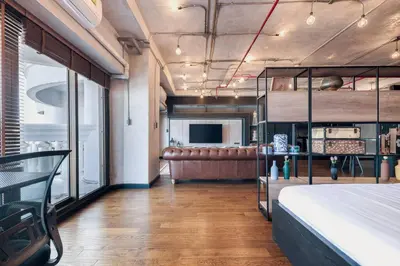 a bedroom with a bed and a couch in a room at Central Bangkok Loft Style Skyline 100 sq.m. Apt in Bangkok