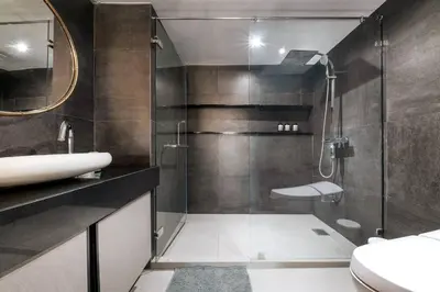a bathroom with a shower and a sink and a toilet at Central Bangkok Loft Style Skyline 100 sq.m. Apt in Bangkok