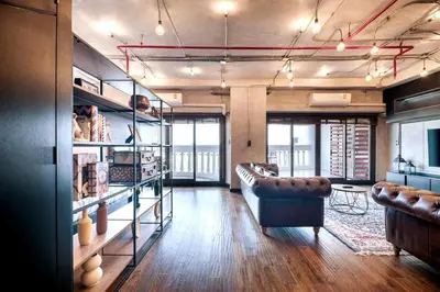 a room with a couch and a table and some chairs at Central Bangkok Loft Style Skyline 100 sq.m. Apt in Bangkok