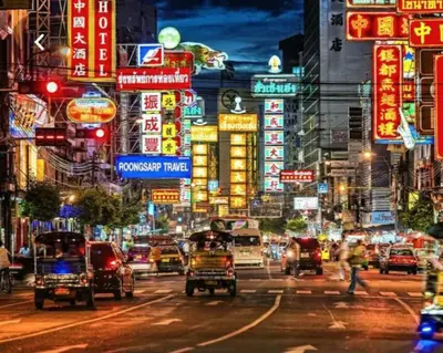 a busy city street at night with cars and signs at I'M Chinatown Residence Yaowaraj Bangkok Watmungkorn MRT Station in Bangkok