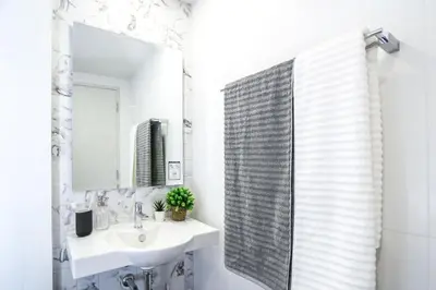 a bathroom with a sink and a mirror at I'm Chinatown Residence in Bangkok