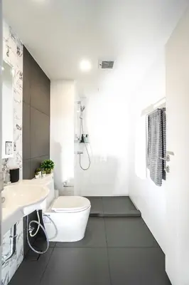 a white bathroom with a toilet and a sink at I'm Chinatown Residence in Bangkok
