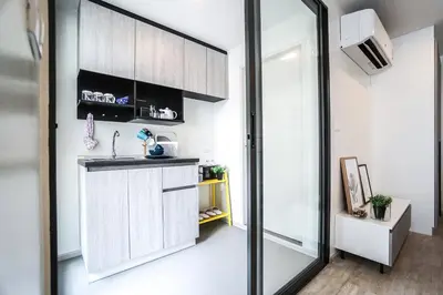 a kitchen with a sink and a mirror at I'm Chinatown Residence in Bangkok