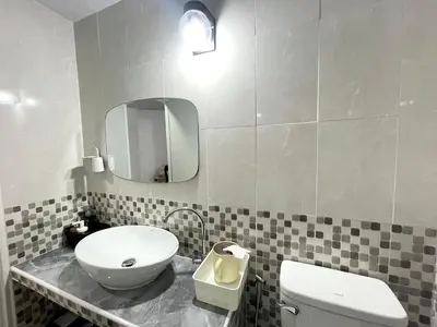 a bathroom with a sink and a toilet and a mirror at Lively Impact C3-C9 in Nonthaburi