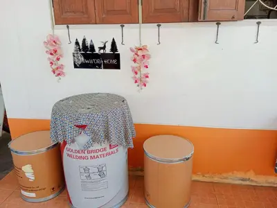 a kitchen with two trash cans and a counter at Worakarn Apartment 1 in Bangkok