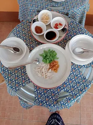 a table with plates of food and bowls of food at Worakarn Apartment 2 in Bangkok