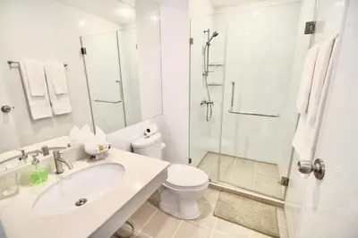 a white bathroom with a sink and a shower at Town Sukhumvit 71 in Bangkok