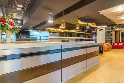 a kitchen with a long counter and a room at De Lux Bangkok Hotel in Ban Khlong Lat Bua Khao