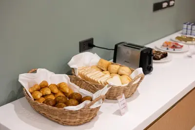 two baskets of bread and pastries on a counter at Pure Eleven Hotel Bangkok in Bangkok