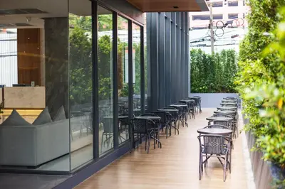 a row of tables and chairs on a patio at Pure Eleven Hotel Bangkok in Bangkok