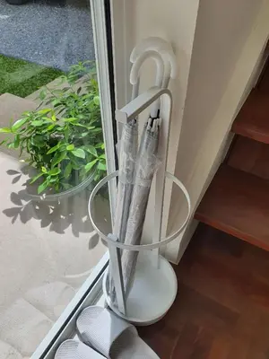 a glass container with pens in it next to a window at InJoy Snow Hotel in Ban Chuat Plai Mai
