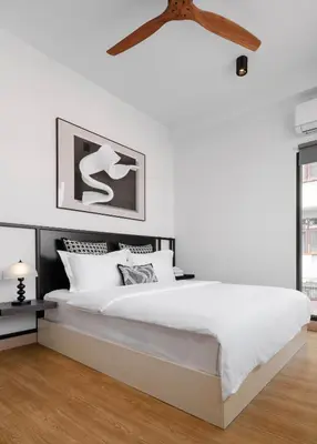 a white bedroom with a large white bed and a ceiling at CASA BLANCA Dusit in Dusit