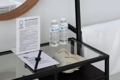 a glass table with two bottles of water on it at CASA BLANCA Dusit in Dusit