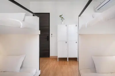 a bedroom with two bunk beds and a mirror at CASA BLANCA Dusit in Dusit