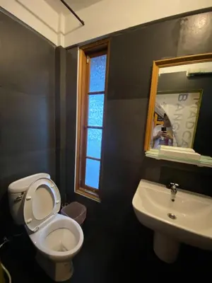 a bathroom with a toilet and a sink and a mirror at T-House BKK 2Floors near BTS with swimming pool and free Wifi in Khlong Toei