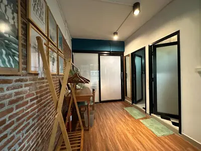 a hallway with a brick wall and a staircase at T-House BKK 2Floors near BTS with swimming pool and free Wifi in Khlong Toei