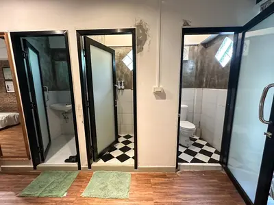 a bathroom with two mirrors and a toilet at T-House BKK 2Floors near BTS with swimming pool and free Wifi in Khlong Toei