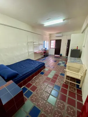 a room with a bed and a tiled floor at Ratanawong Place 402 in Bangkok