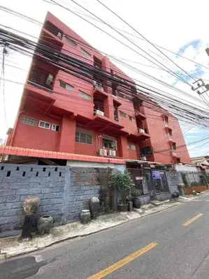 a red building on the side of a street at Ratanawong Place 402 in Bangkok