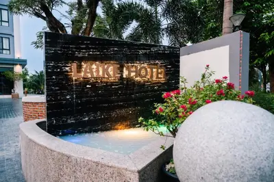 a sign for a hotel with a water fountain at Laike Hotel in Bangkok