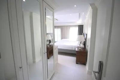a bathroom with a mirror and a bedroom with a bed at SASHA HOUSE in Ban Yang