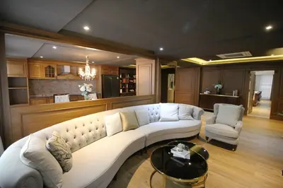 a living room with a large white couch and chairs at SASHA HOUSE in Ban Yang